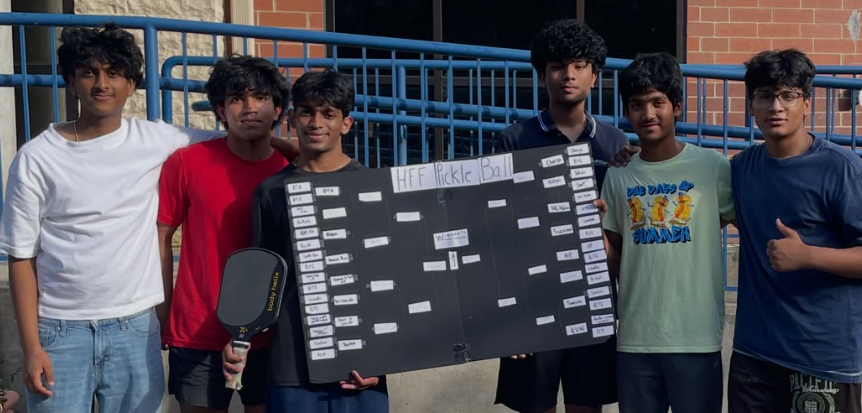 HFF pickleball sports fundraiser group holding a tournament bracket board